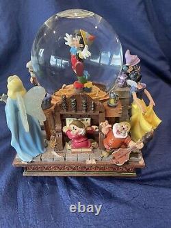 Disneys Pinocchio & Snow White Share a Dream Come True Musical big snow globe