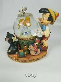 Pinocchio snow globe music box Toyland Disney Everything works great Rare