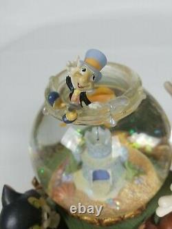 Pinocchio snow globe music box Toyland Disney Everything works great Rare